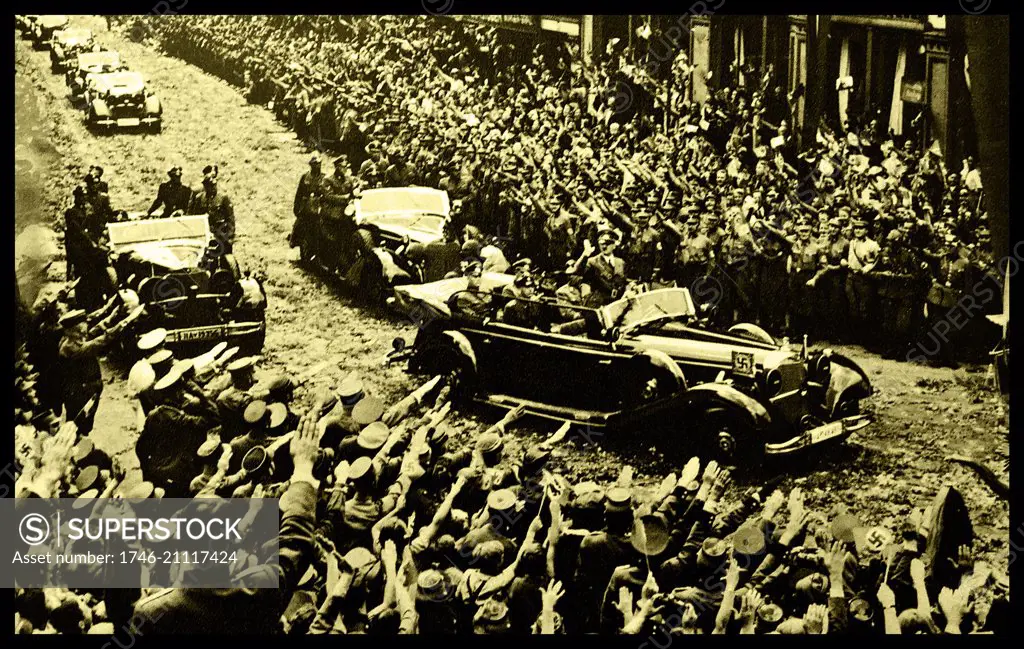 Adolf Hilter is shown saluting Nazi supporters from his car during a rally, taken shortly after the occupation of France in 1940, during the Second World War.