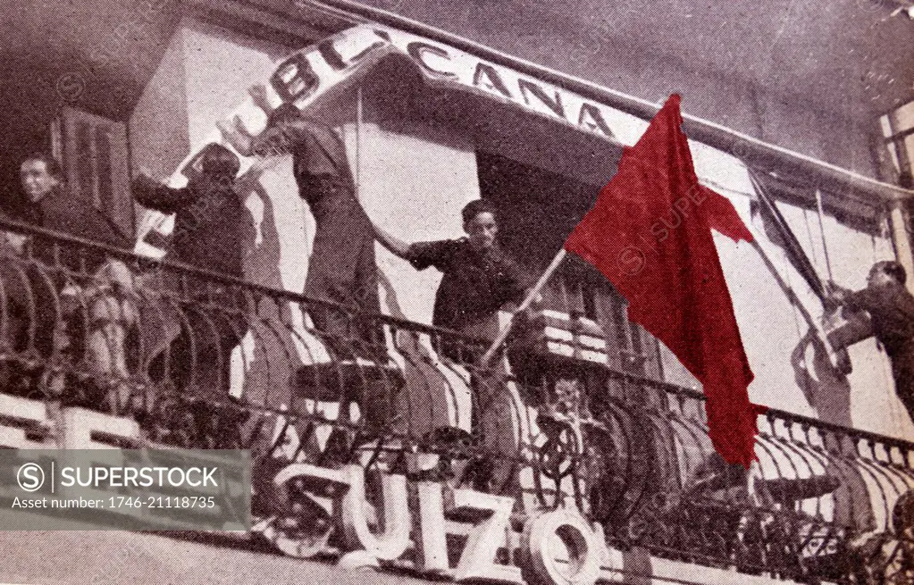 Communist flag is removed from a rebuplican building by falangist soldiers during the Spanish Civil War. Dated 1938