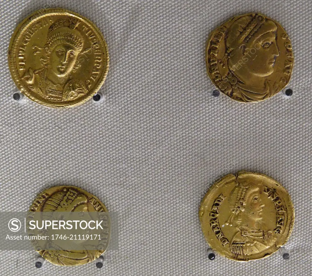 Four Roman Gold Coins issued by the Emperors Constantius II, Valetinian, Valens and Arcadius.