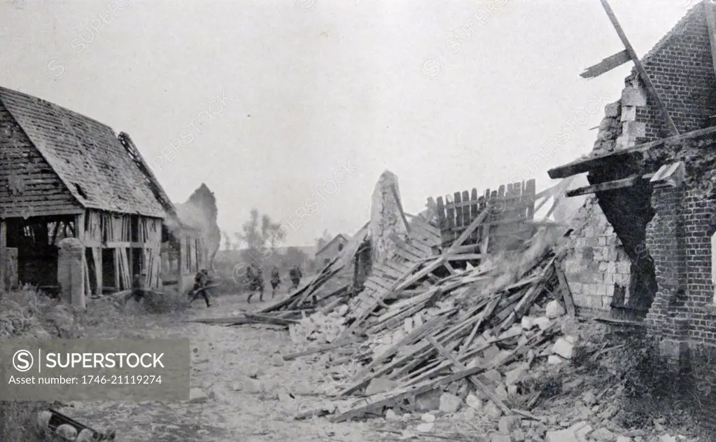 German soldiers advance across a ruined French village during World war One 1915