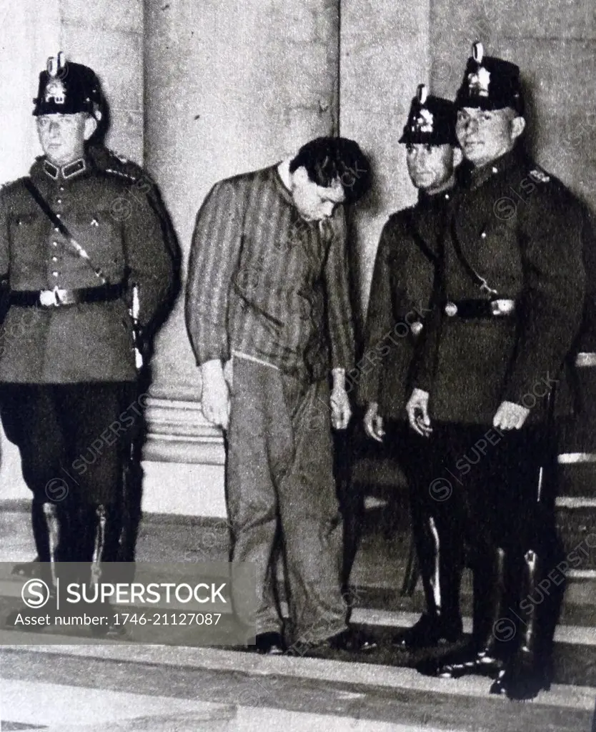 Photographic print of Marinus van der Lubbe (1909-1934) with police officers outside of the court. Marinus van der Lubbe, a Dutch council communist who was convicted for setting fire to the Reichstag Building. Dated 20th Century