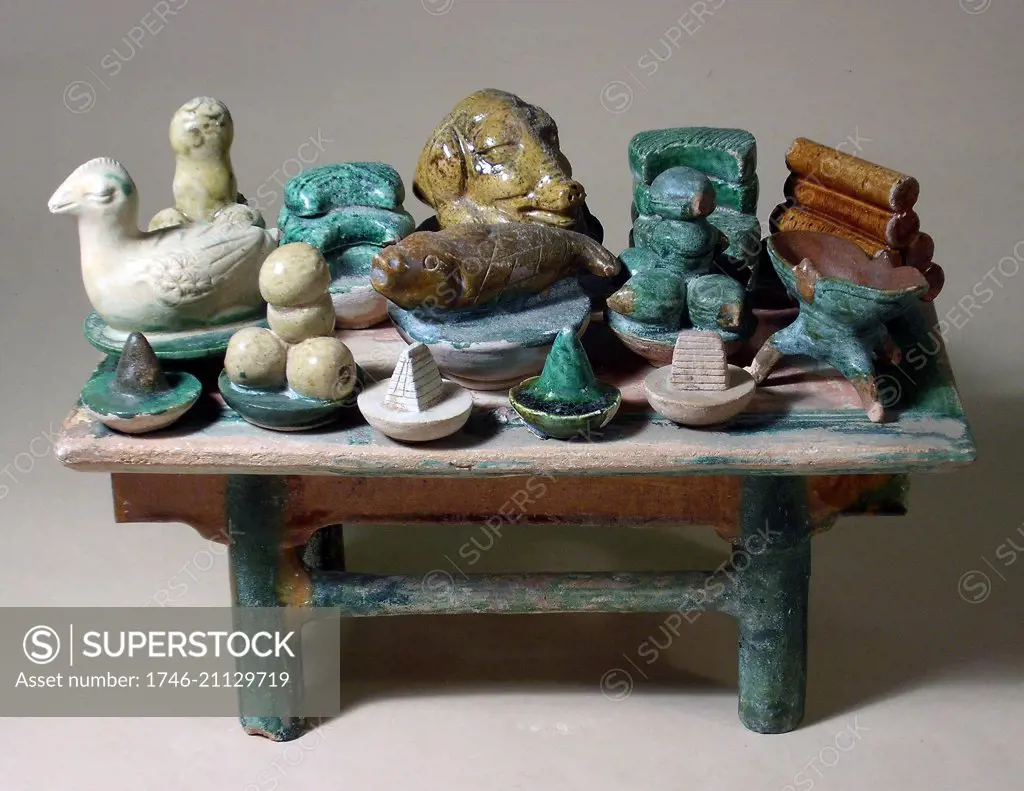 Ancient China: Offering table wth ceramic food objects. Glazed green and orange ware. Ming dynasty, 1368 - 1644 AD.