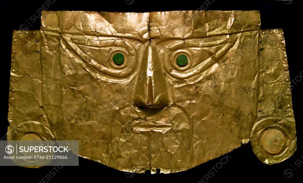 Pre-Columbian art: Chimu gold burial mask, with shell ear-plugs and dark green stone eyes, from northern Peru, 1100 - 1400 AD. This mask would have been placed on the face of a mummy.