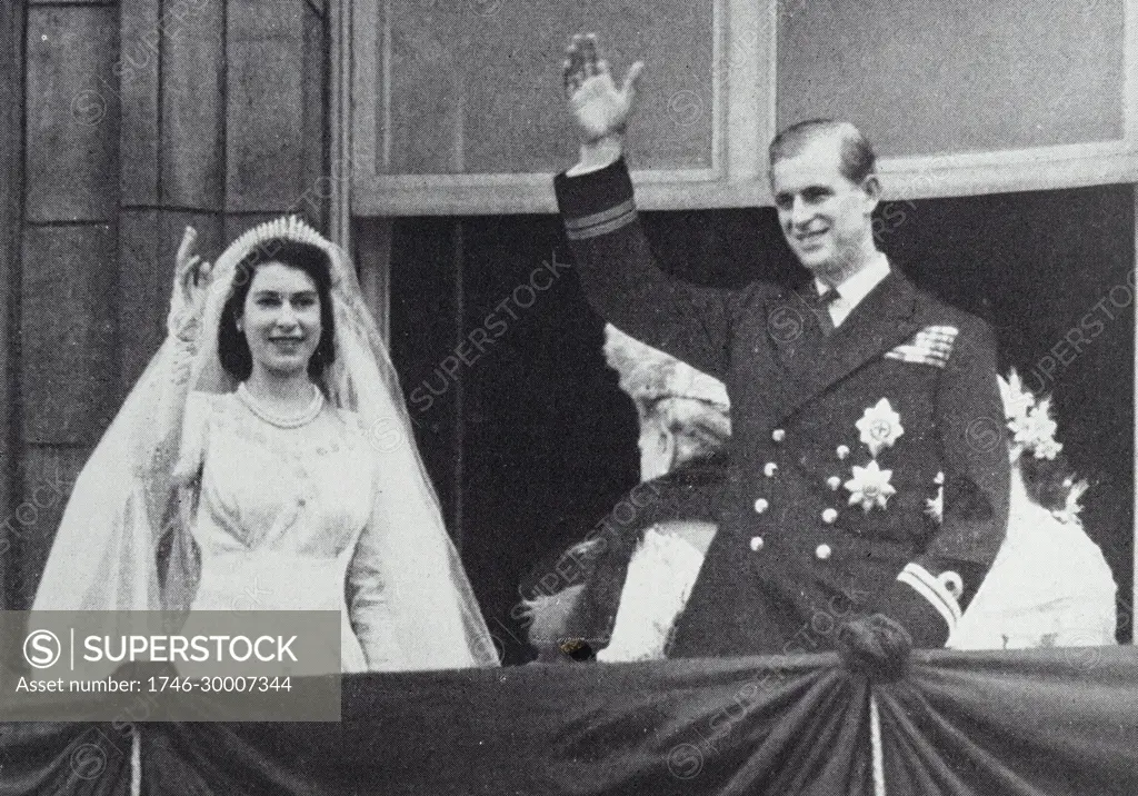Photograph of Queen Elizabeth II and the Duke of Edinburgh waving from the balcony on their wedding day.