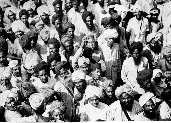 A photograph taken during the Gandhi movement in India. People crowd the streets of Amritsar to watch a demonstration of the disciples of Gandhi. Dated 20th century