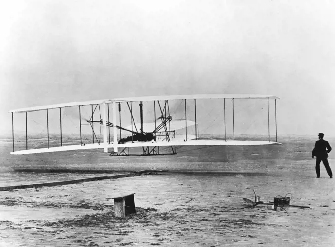 The first powered flight, December 17 1903, Kitty Hawk, North Carolina. Wilbur and Orville Wright. Photograph Acknowledgement must be made to The Smithsonian Institution