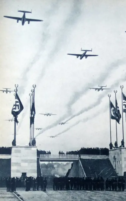 Photograph of fighter planes flying over a Nazi Rally. Dated 1941