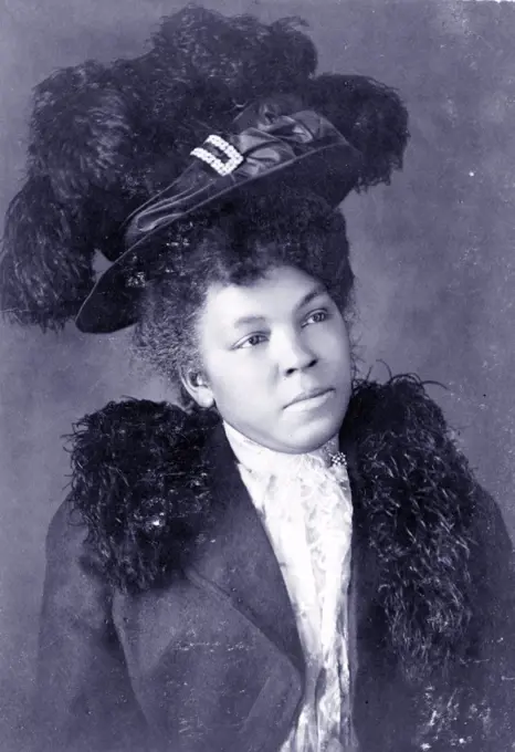 Young African American woman, half-length portrait, facing right, wearing hat. Published 1899 or 1900.