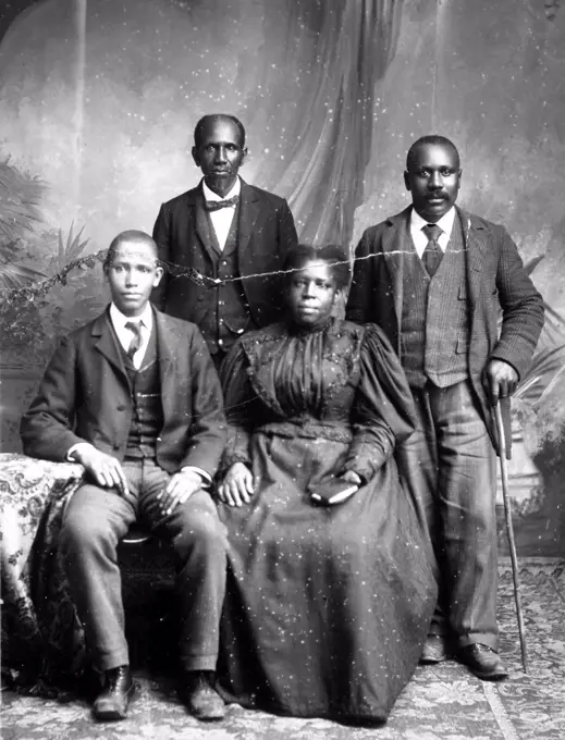 Officers of Tobacco Trade Union, Petersbury, Va. Published 1899. Two African American men standing and an African American man and woman seated.