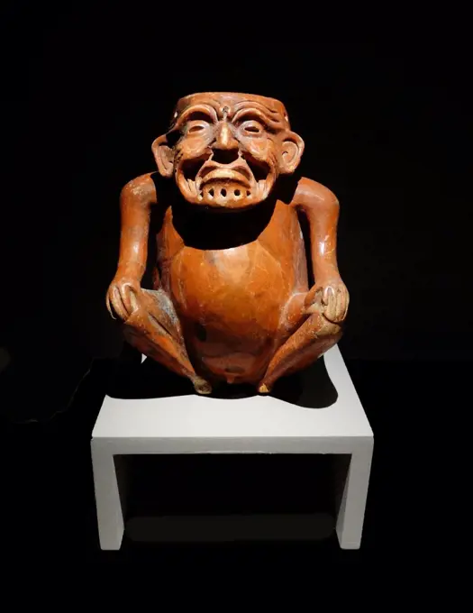 Mayan ceramic anthropomorphic pot, depicting an old man seated with his hands upon his knees. 600-900 AD Xcambo, Yucatan, Mexico