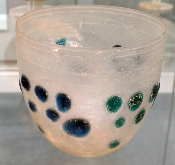Blown glass cup decorated with applied blue and green blobs Roman, probably made in the eastern Mediterranean, 4th century AD