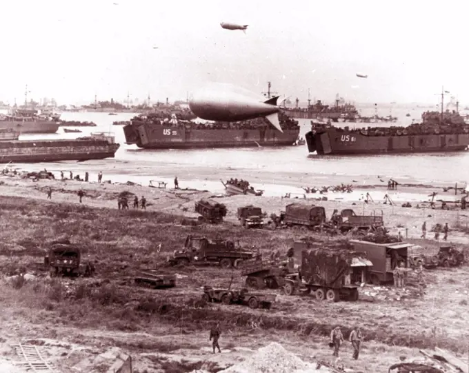 Photograph of D-Day landing vehicles, vessels used to convey a landing force (infantry and vehicles) from the sea to the shore during an amphibious assault. Dated 1944