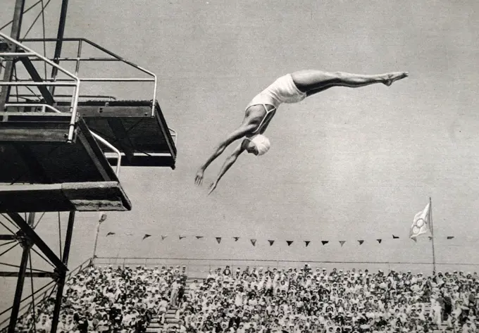 Photograph of Jane Fauntz (1910 - 1989) competing in the springboard diving event at the 1932 Olympic games. She took home the bronze medal for the USA in the event. 