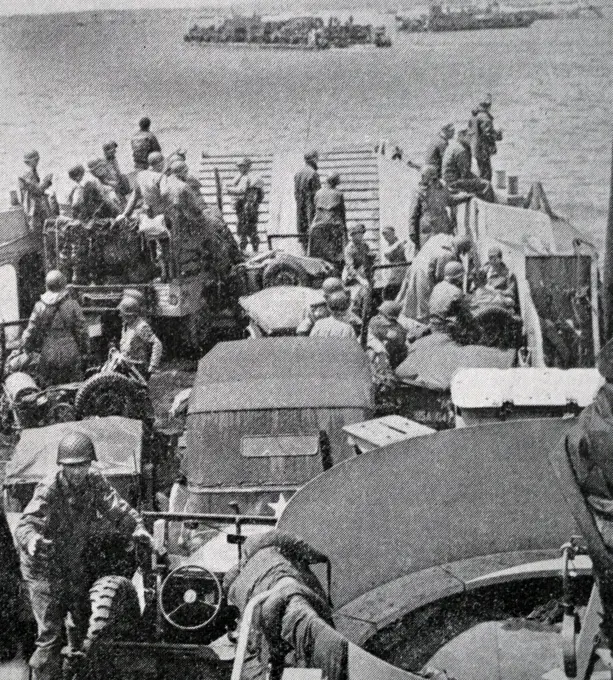 Black and white photograph of World War II (1939-1945) showing images from the Allied sea invasion of Normandy on D-Day, 6 June 1944; American reinforcements arrive.