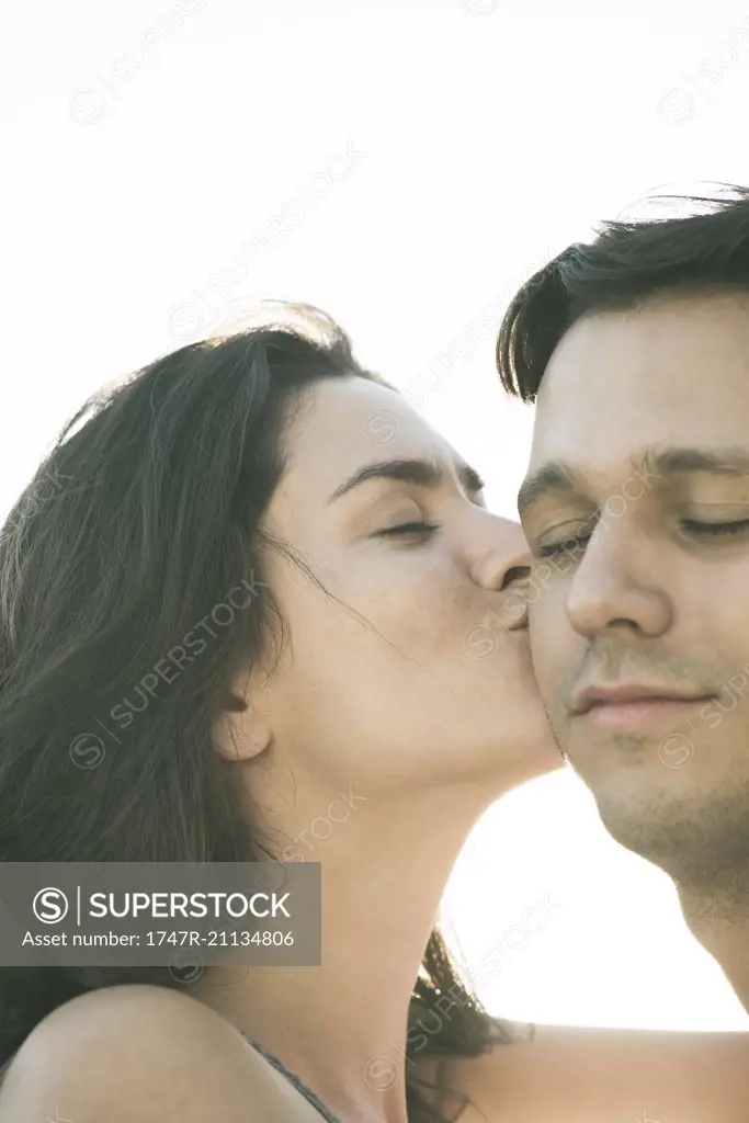 Woman kissing husband on cheek