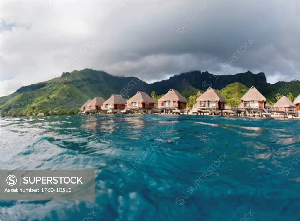 French Polynesia, Moorea Lagoon Resort, Bungalows over beautiful turquoise ocean.