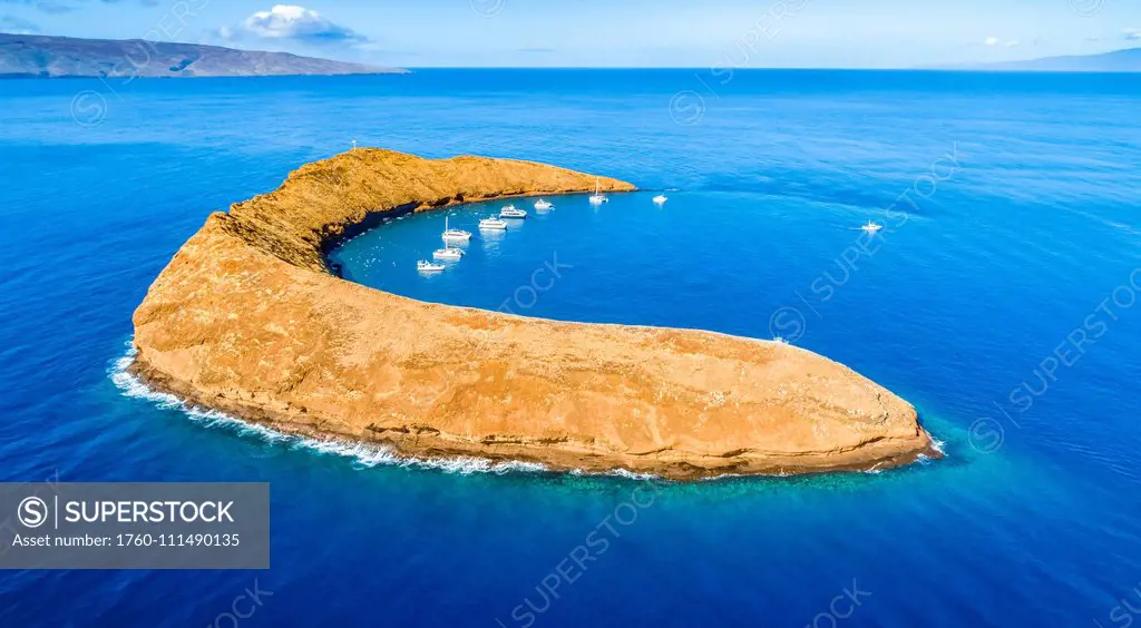 Molokini Crater, aerial shot of the Maui side of the crescent shaped islet with Kahoolawe and Lanai in the distance; Maui, Hawaii, United States of Am...