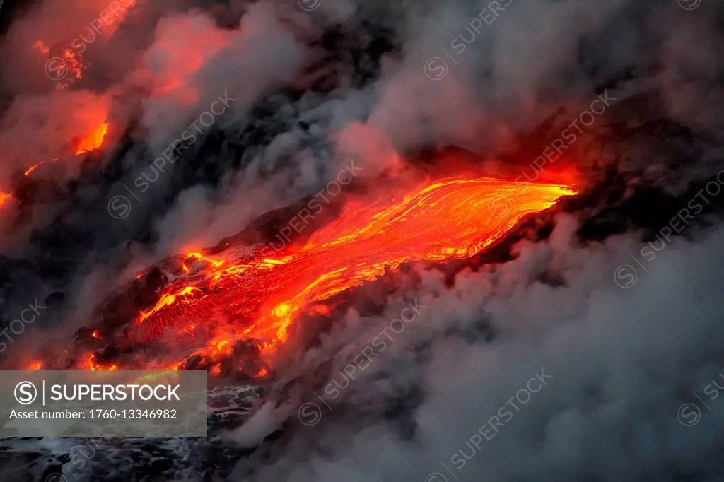 Flowing lava and steam on a hawaiian island; Island of Hawaii, Hawaii, United States of America