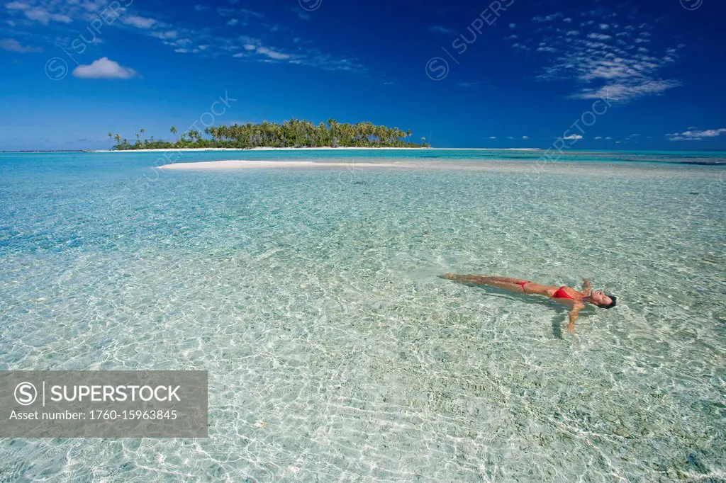 French Polynesia, Tahiti, Rangiroa, Woman Floating In Water.