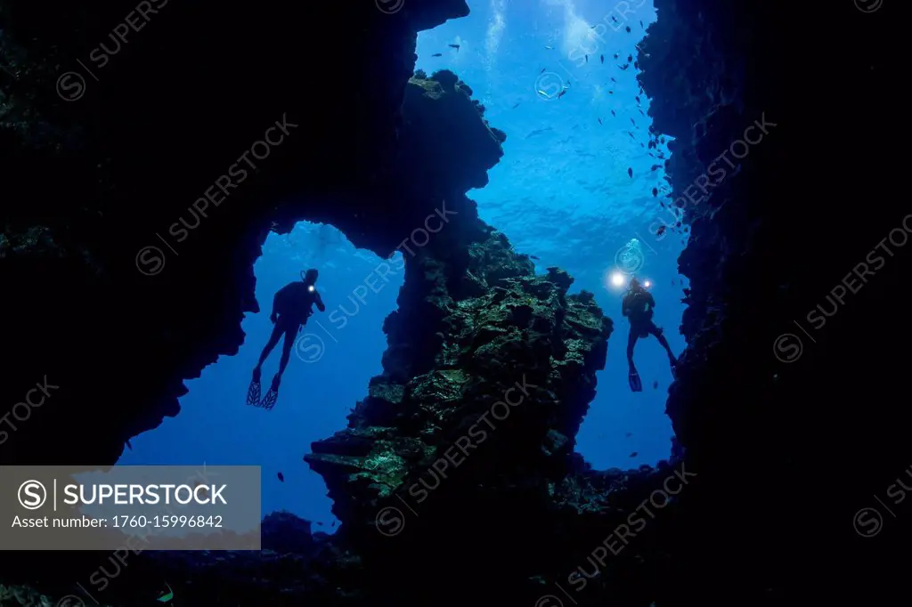 Divers pictured at the entrance to Second Cathedral off the Island of Lanai; Lanai, Hawaii United States of America