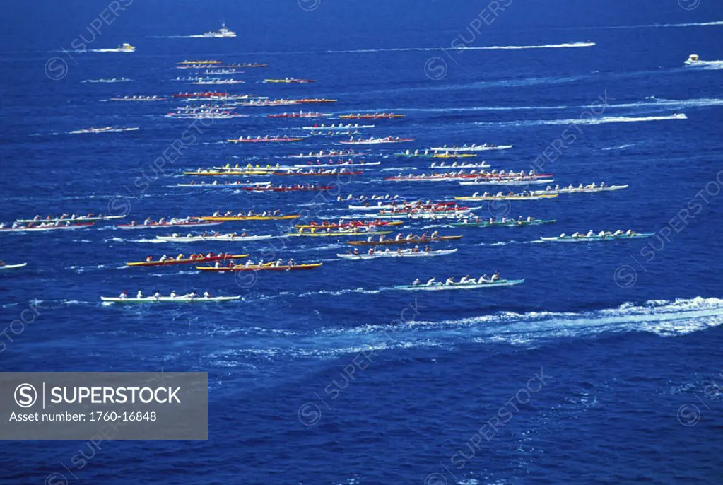 Hawaii, Big Island, Kona, Aerial side view of Queen Liliuokalani canoe race, colorful