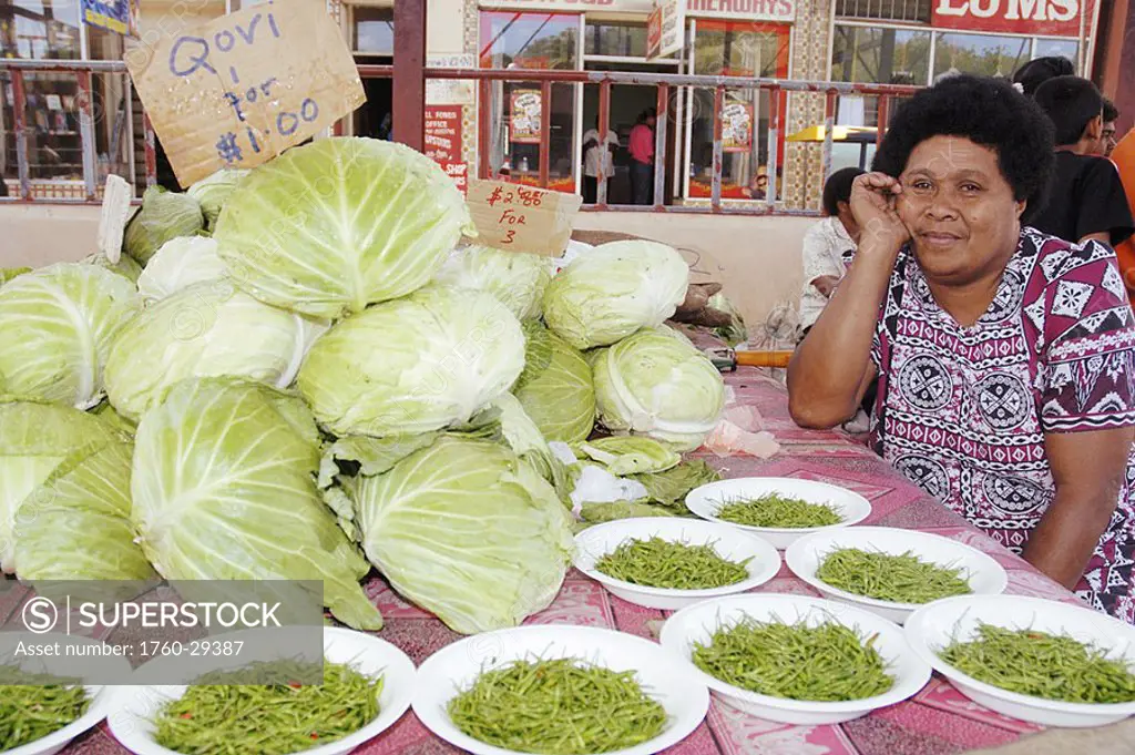 Fiji, Viti Levu, Sigatoka, fijian woman in traditional dress selling cabbage and hot peppers in the market