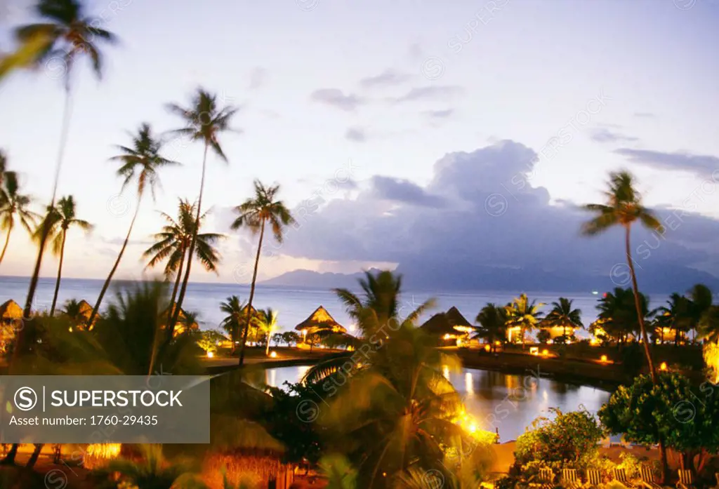 French Polynesia, Tahiti, Overview of Hotel Sofitel Maeva Beach at dusk