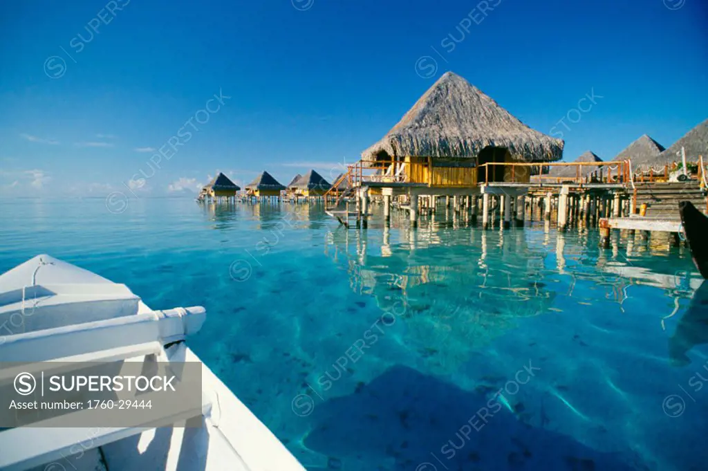 French Polynesia, Tahiti, Bora Bora, Moana Beach Hotel bungalows seen from outrigger canoe