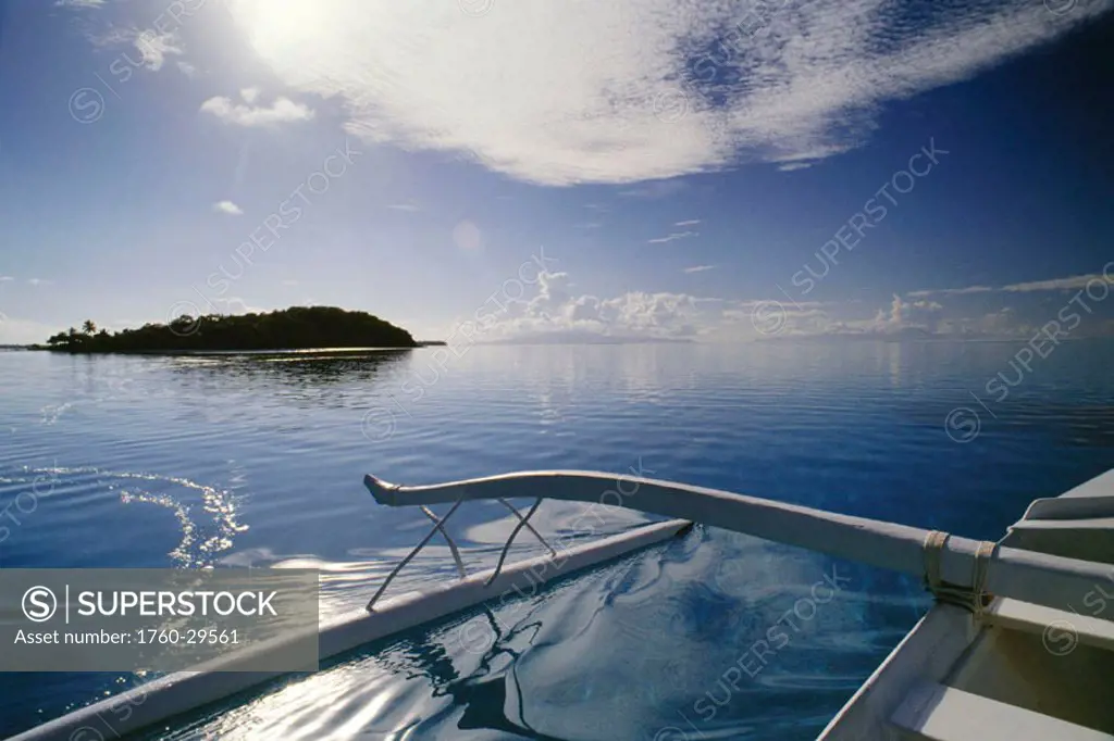 French Polynesia, Tahiti, Outrigger in coral waters of Bora Bora, Motu in background