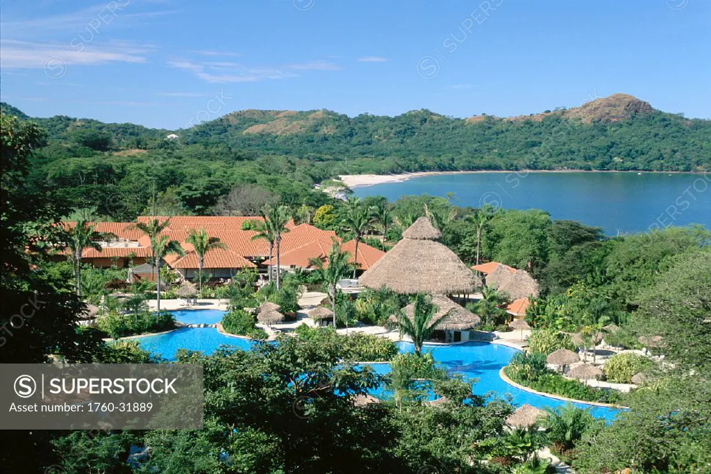 Costa Rica, Melia Playa Conchal, grounds w/ pool, bay in background, blue sky