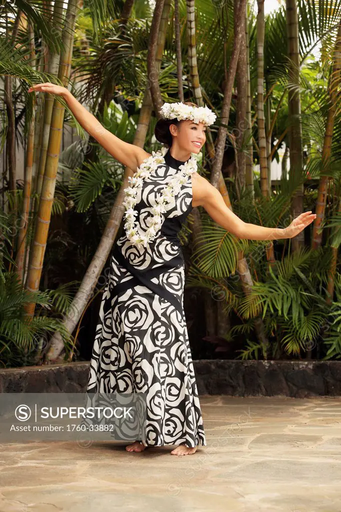 Hawaii, A local Hawaiian woman wearing a lei and a Hawaiian print dress.