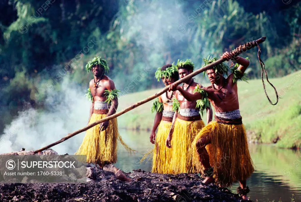 Fiji, Natives in traditional costume prepare coals for fire walking