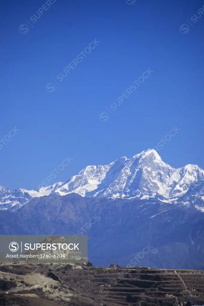 Nepal, Nagarkot, Hotel Chautari Keyman on hillside, central Himalayan mountains in background.