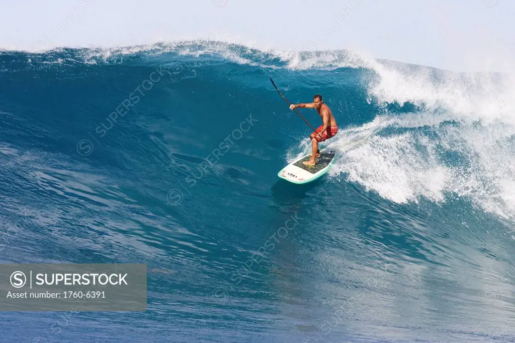 Hawaii, Oahu, Makaha, Brian Keaulana paddle surfing a big wave 