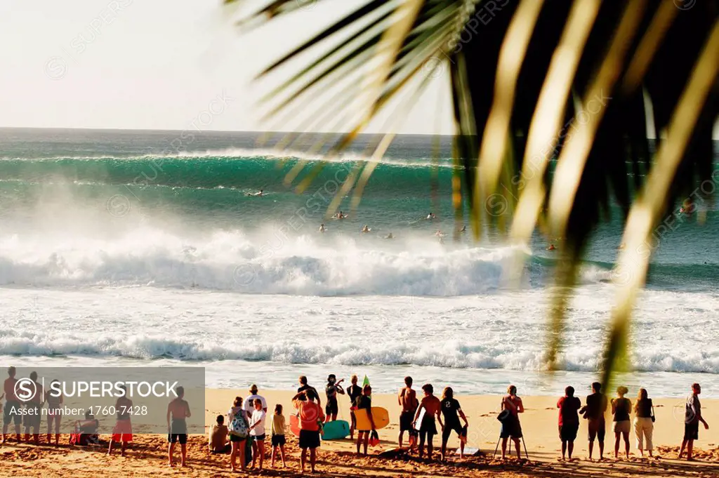 Hawaii, Oahu, North Shore, spectators watch crashing surf from sand