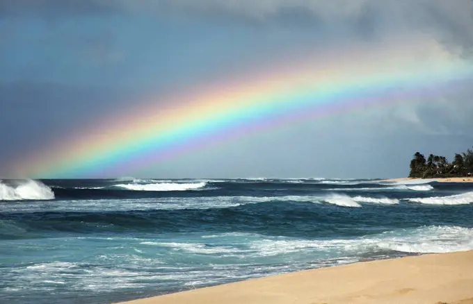 Hawaii, Oahu, North Shore, Rainbow over the ocean.