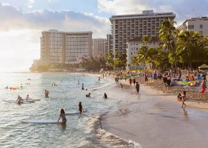 Tourists on Waikiki Beach; Honolulu, Oahu, Hawaii, United States of America