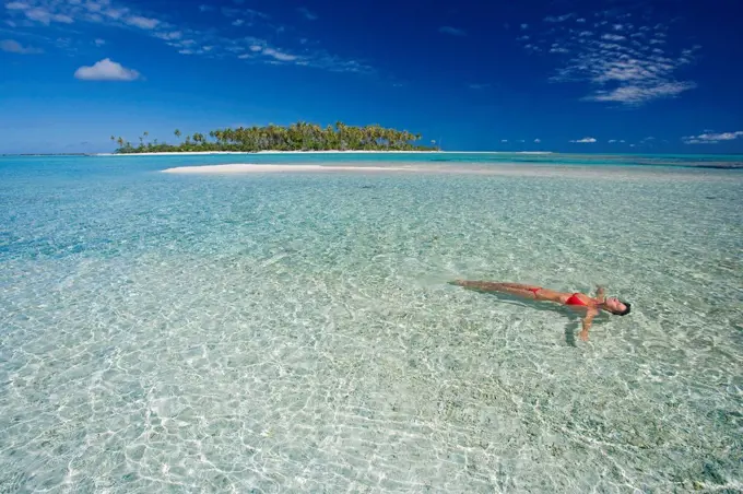 French Polynesia, Tahiti, Rangiroa, Woman Floating In Water.