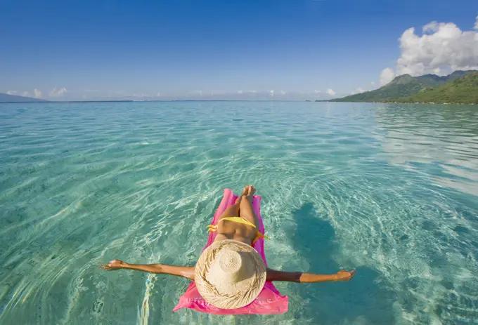 French Polynesia, Tahiti, Moorea, Woman Floating In Water.