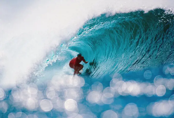 Hawaii, Oahu, North Shore, Pipeline, Shimmering water in foreground of Liam in wave curl