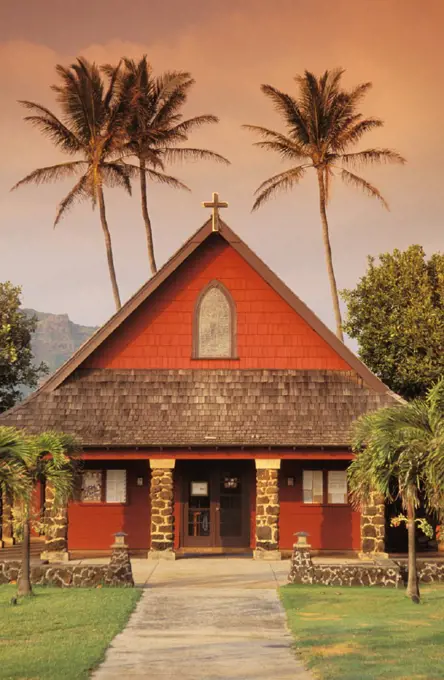 Hawaii, Kauai, North Shore, front view of church with tall palm trees background.