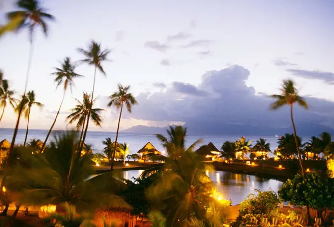 French Polynesia, Tahiti, Overview of Hotel Sofitel Maeva Beach at dusk