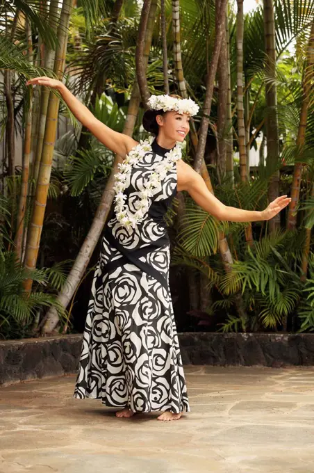 Hawaii, A local Hawaiian woman wearing a lei and a Hawaiian print dress.