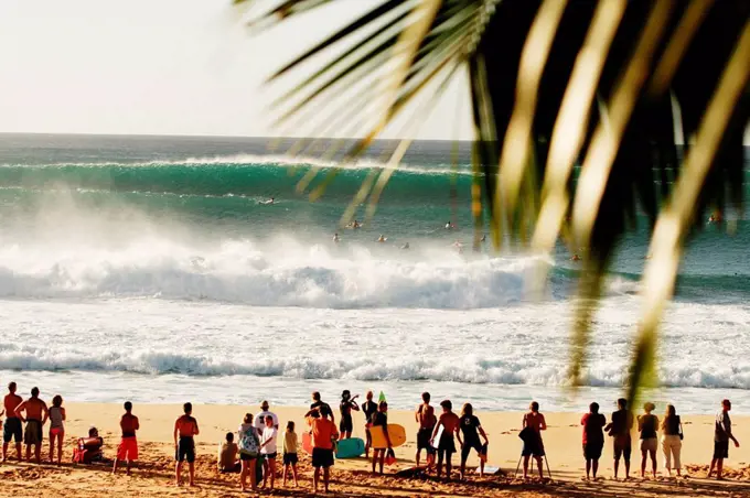 Hawaii, Oahu, North Shore, spectators watch crashing surf from sand