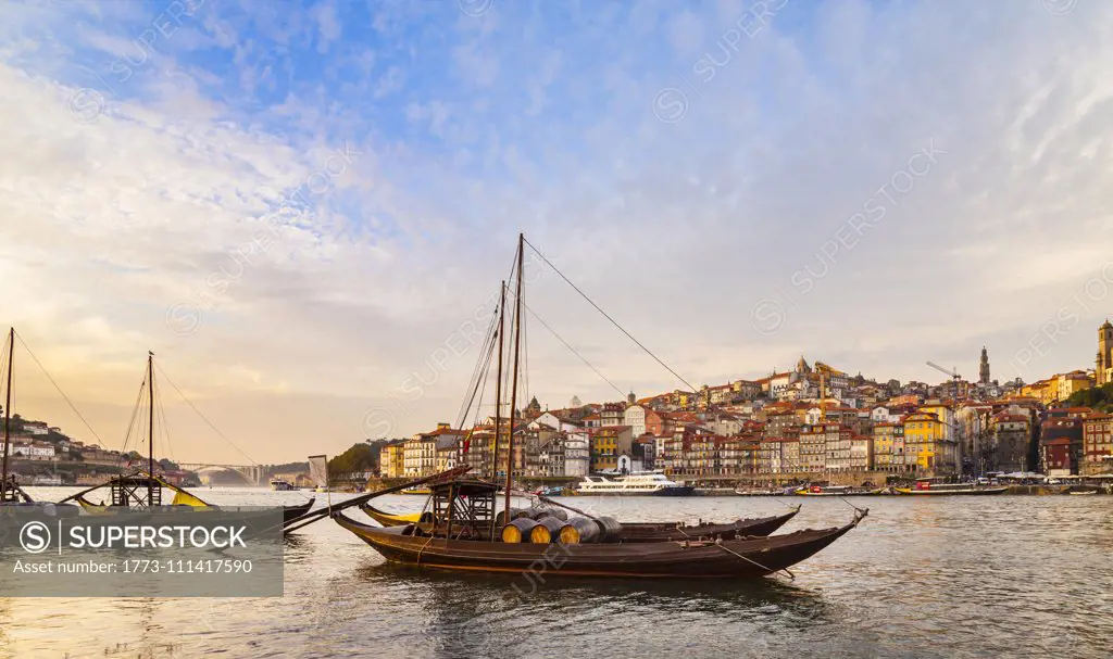 Traditional Portuguese wooden cargo boats transporting port wine on Douro River, Porto, Portugal