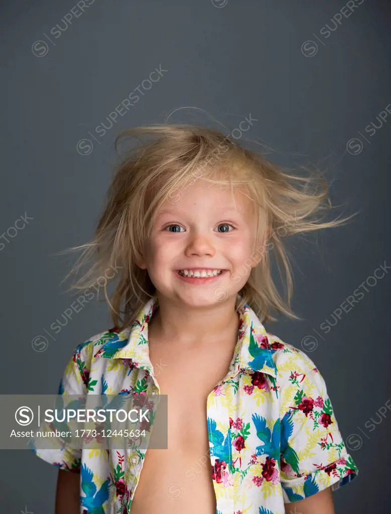 Portrait of young boy with messy hair, smiling