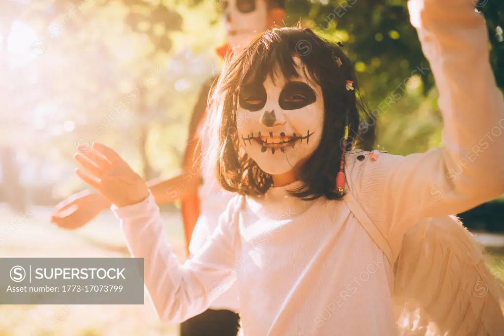 Happy girl in Halloween face paint