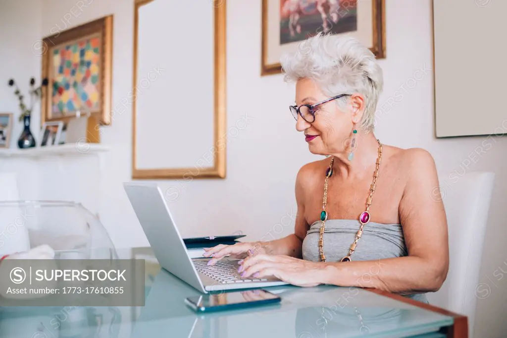 Senior woman working at home