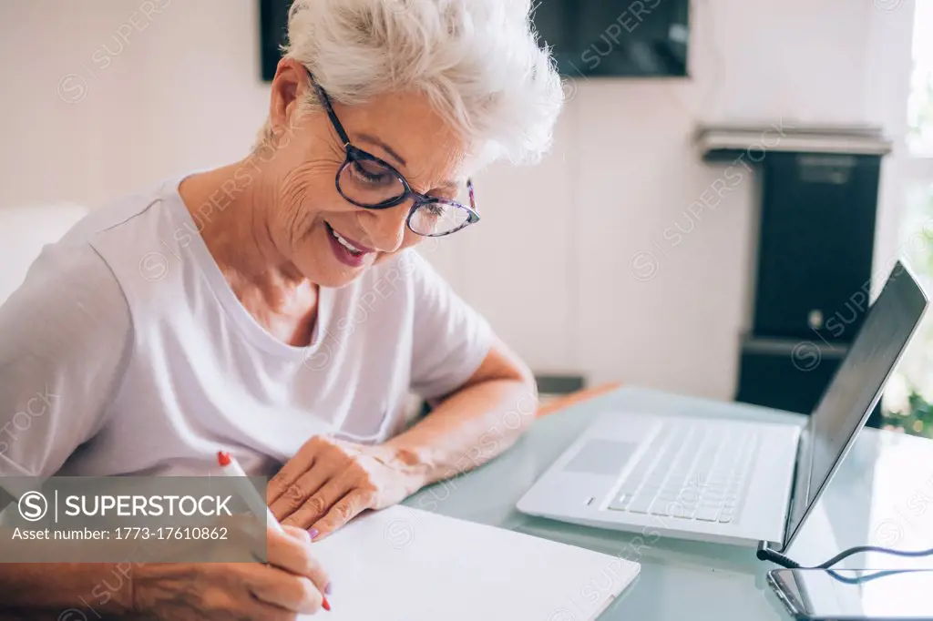 Senior woman working at home