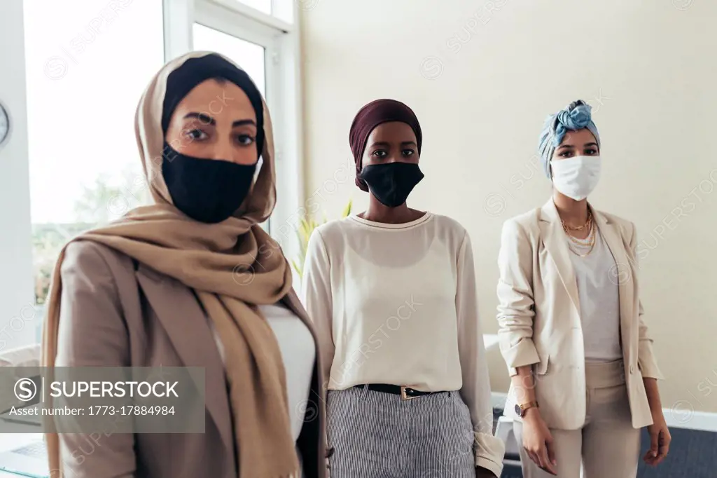 Businesswomen wearing face masks in office